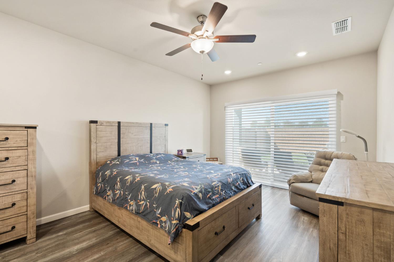 948 Hogan Road Galt, CA 95632 - Photo 10 of 20 a bedroom with a bed and a dresser with wooden floor