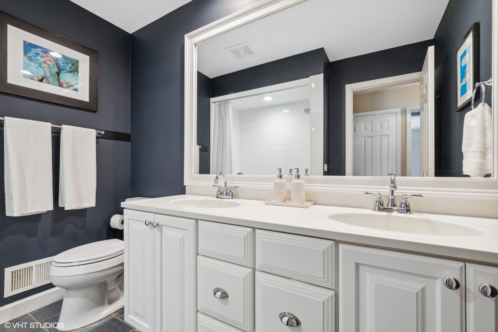 845 Forest Hill Road Lake Forest, IL 60045 - Photo 28 of 41 a bathroom with a toilet a sink a mirror and a window