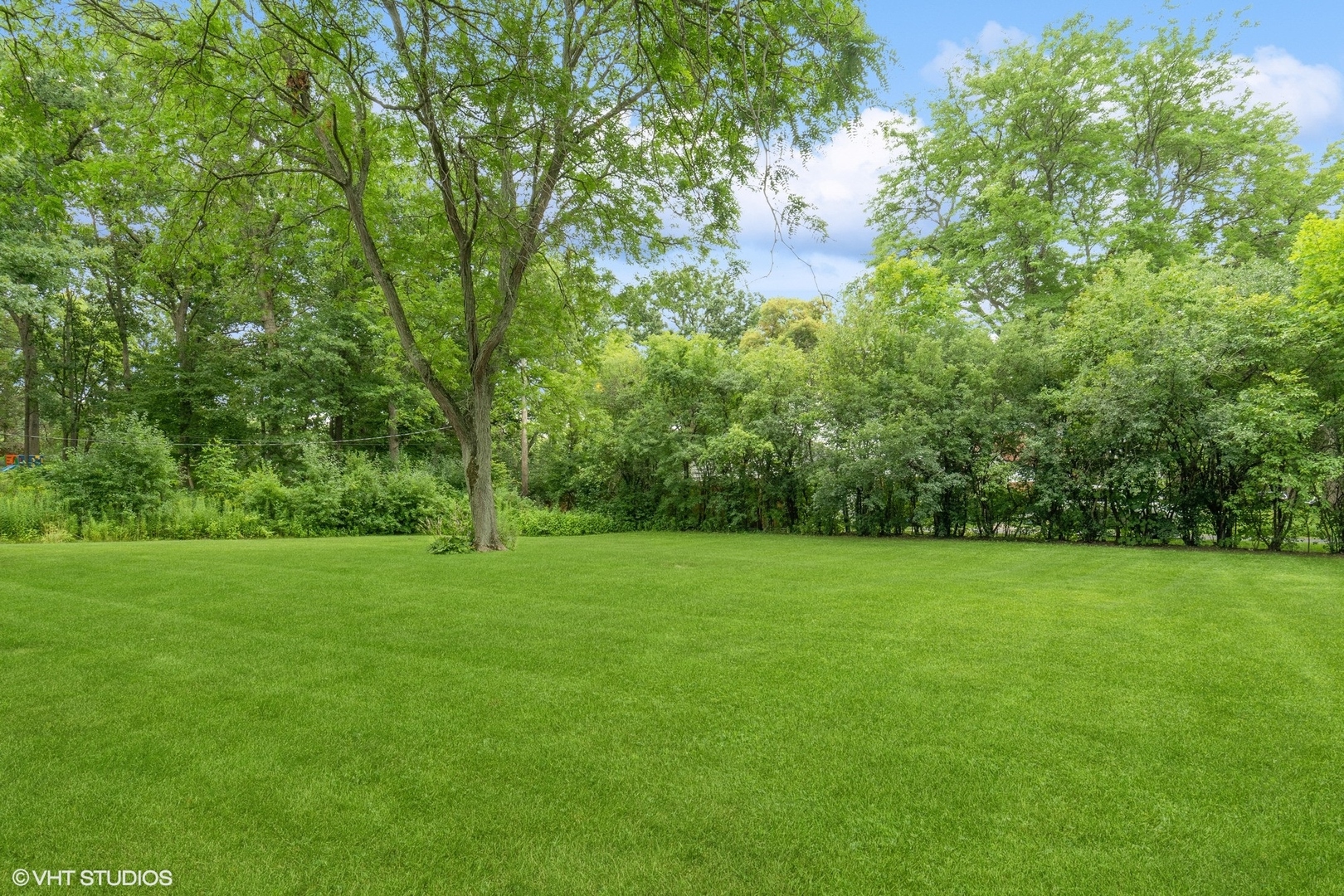 845 Forest Hill Road Lake Forest, IL 60045 - Photo 33 of 41 a view of a grassy field with trees in the background