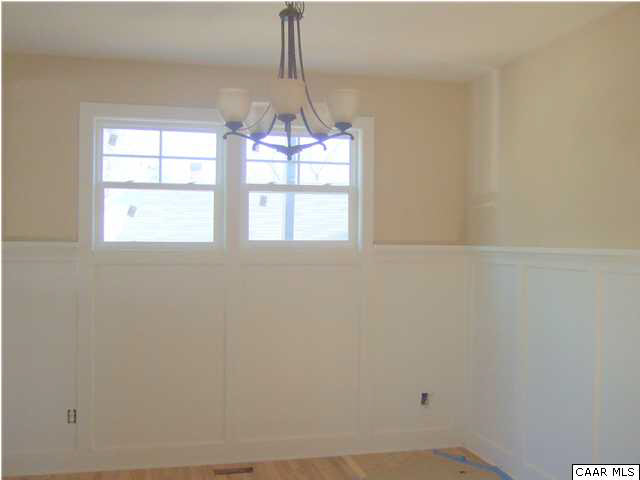 200 Harris Road Charlottesville, VA 22903 - Photo 4 of 15 an empty room with windows and chandelier