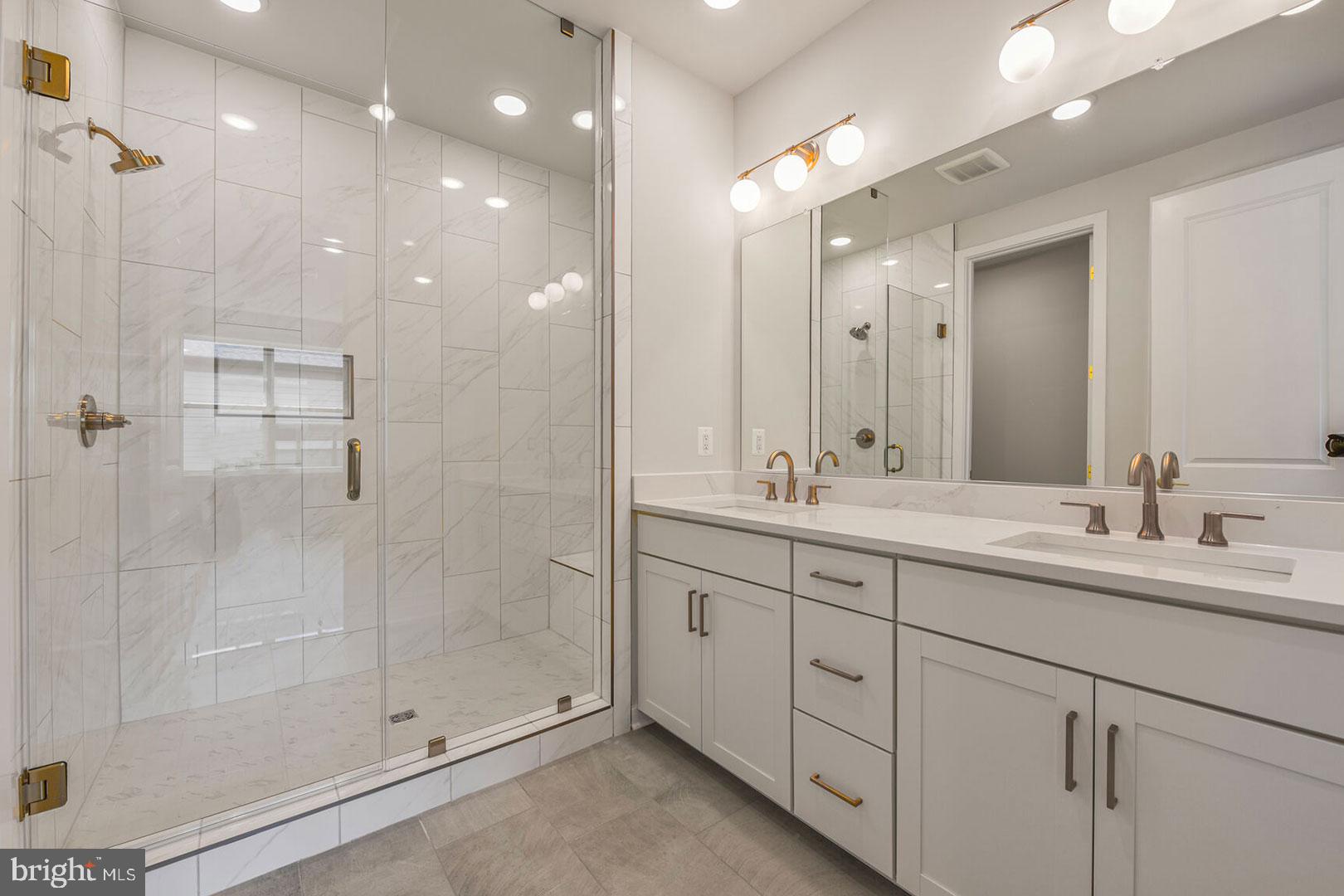 1624 Fellowship Square Reston, VA 20190 - Photo 12 of 18 a bathroom with a double vanity sink mirror and shower