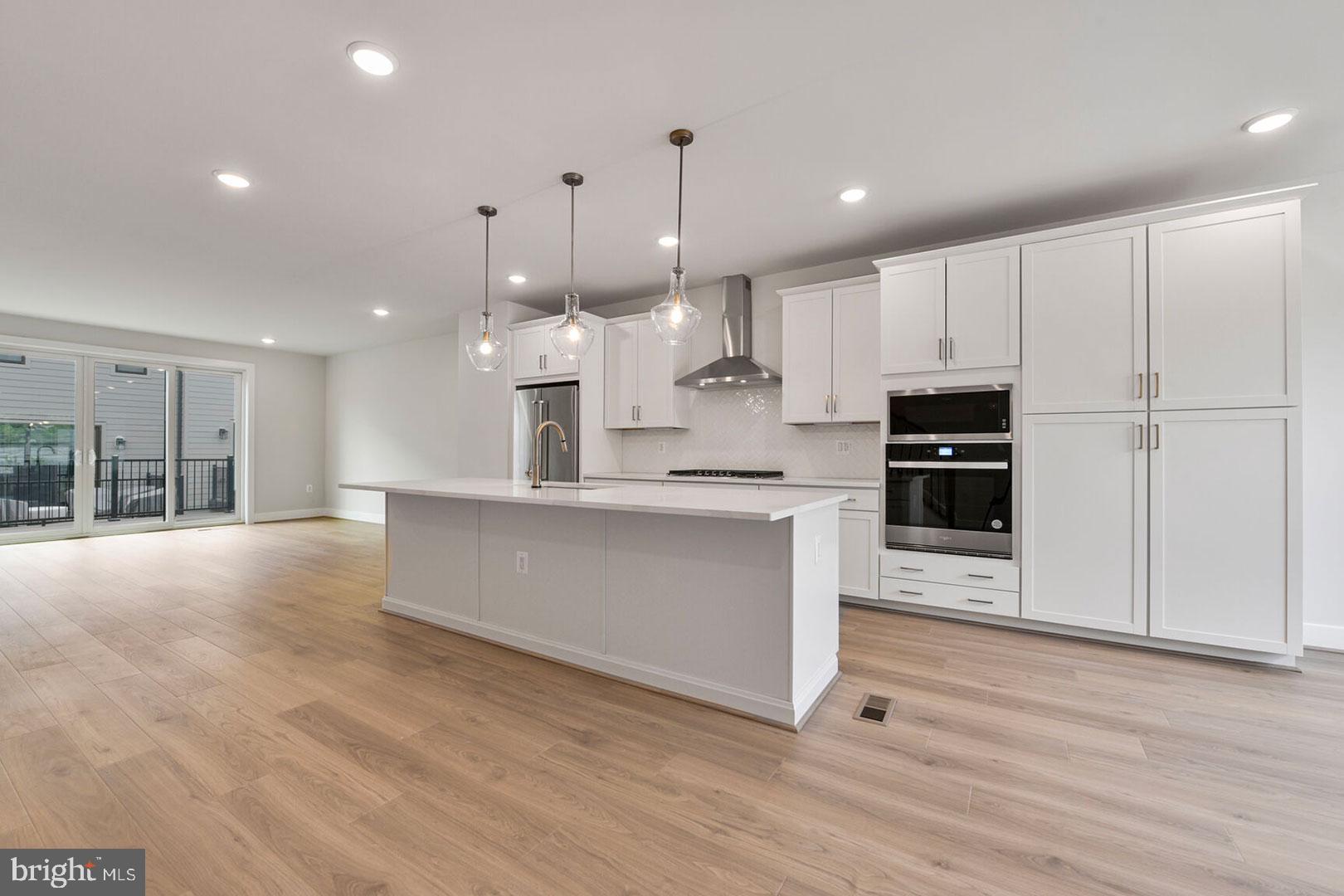 1624 Fellowship Square Reston, VA 20190 - Photo 5 of 18 a large kitchen with kitchen island a sink stainless steel appliances and cabinets