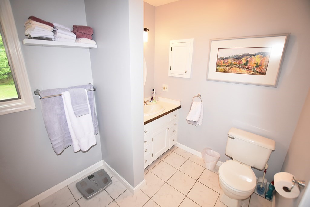 2 Old Waite Road Petersham, MA 01366 - Photo 14 of 42 a white toilet sitting next to a bathroom sink and a mirror