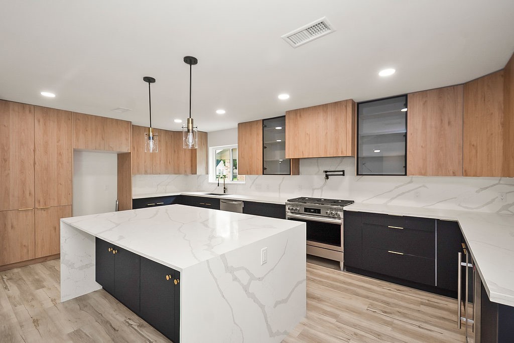 6106 Rutherglenn Drive Houston, TX 77096 - Photo 16 of 41 Designer kitchen featuring quartz countertops, custom European-style cabinetry, and modern lighting.
