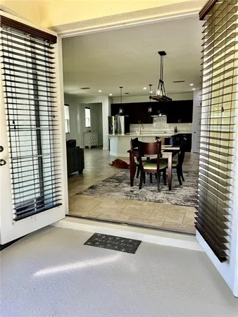 a view of living room with kitchen island furniture and a window