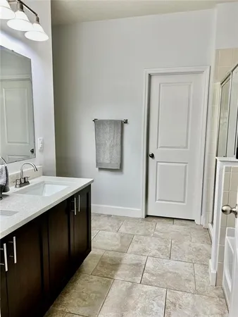 a bathroom with a sink vanity and a mirror