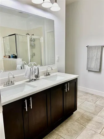 a bathroom with a sink vanity and a mirror