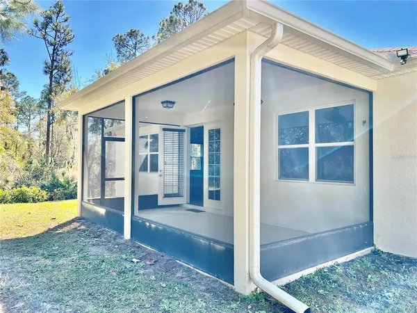 a view of backyard with seating area and trees