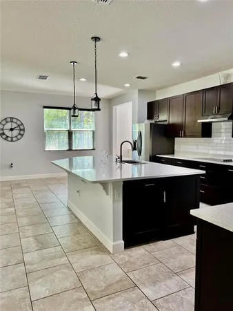a large kitchen with stainless steel appliances a cabinets and a counter top space
