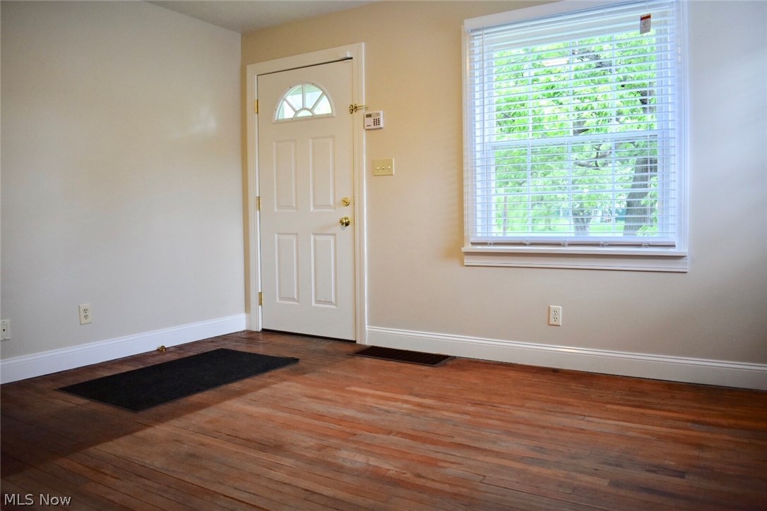 1246 Deforest Road Southeast Warren, OH 44484 - Photo 4 of 26 The living room measures 13x13. The exposed hardwood floors can be finished or carpeted. Lots of natural light comes through the large window. Door is new.