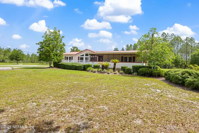 a balcony with view of lake and trees in the background