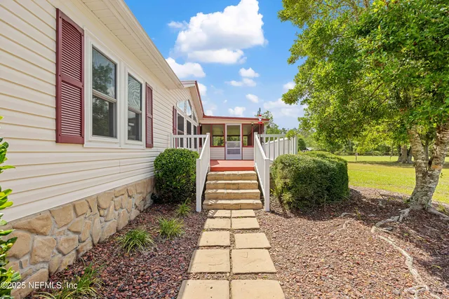 a view of empty room with wooden floor and fireplace