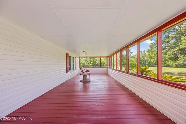 a view of a kitchen with furniture and a refrigerator