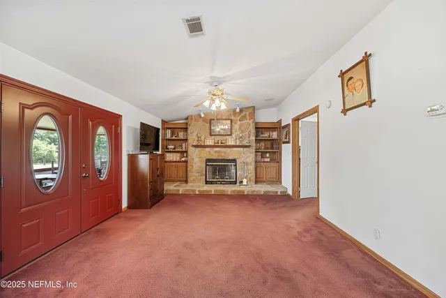 an empty room with closet and a ceiling fan