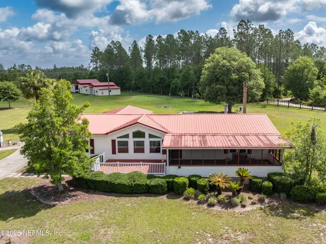 a aerial view of a house with swimming pool and a yard