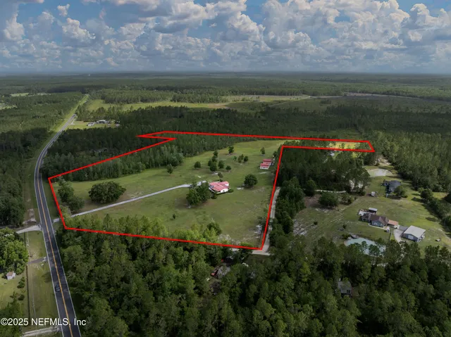 a view of a house with swimming pool and yard