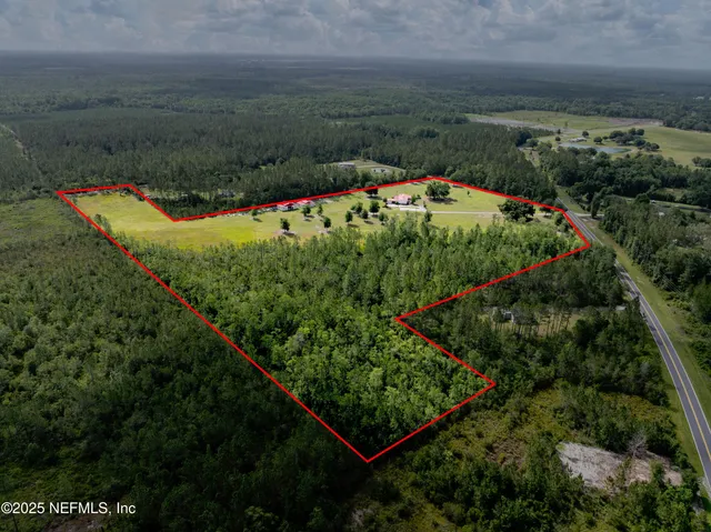 a house view with swimming pool and trees in the background