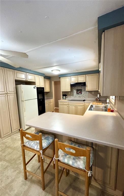 135 Oak Street Edgewater, FL 32141 - Photo 4 of 19 a kitchen with a table chairs and a refrigerator