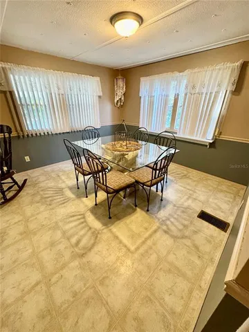 a view of a dining room with furniture and a window
