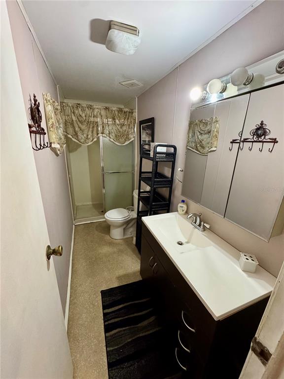 135 Oak Street Edgewater, FL 32141 - Photo 9 of 19 a bathroom with a sink toilet and shower