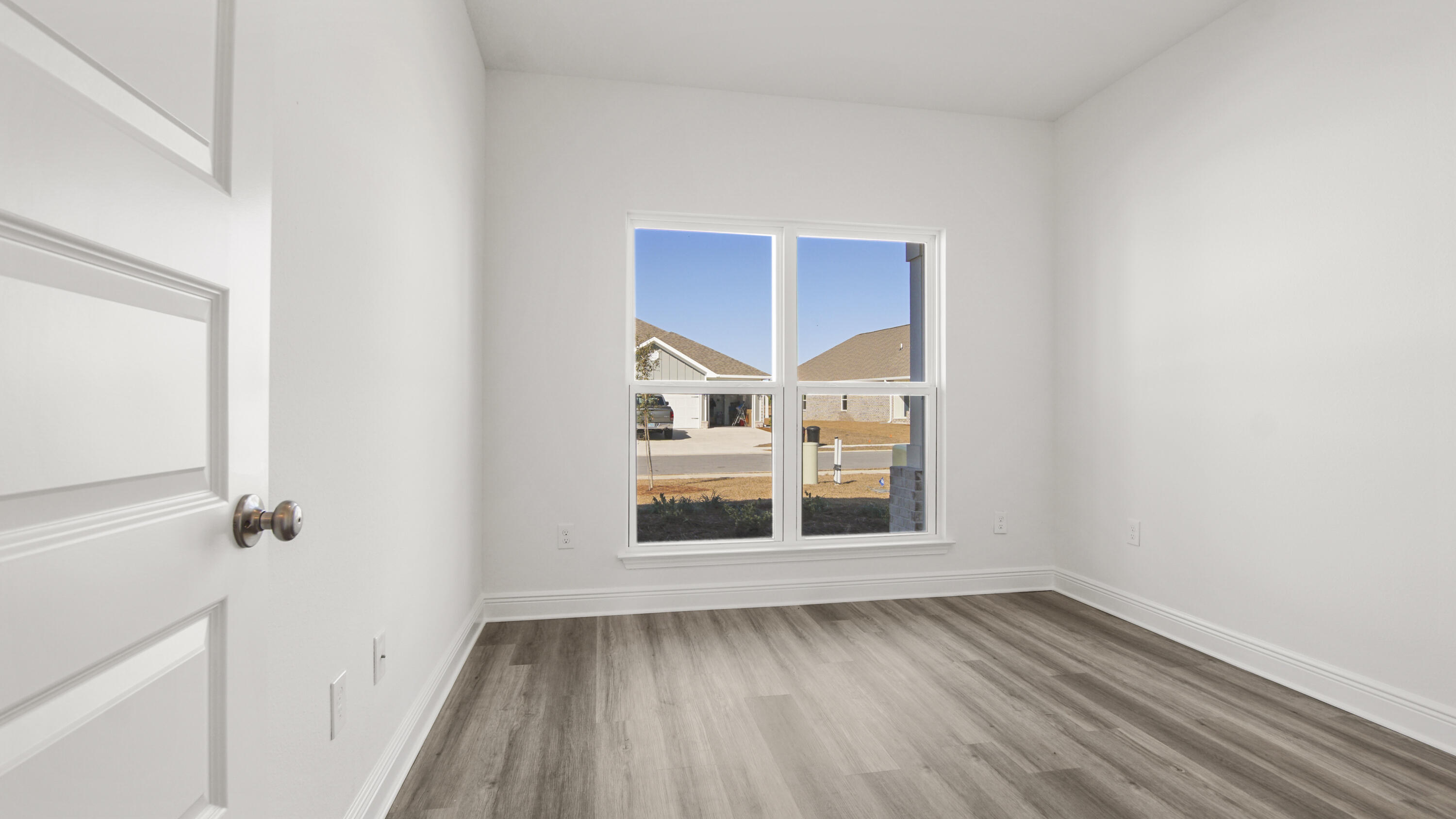 13 West W Farm Freeport, FL 32439 - Photo 5 of 38 a view of an empty room with wooden floor and a window