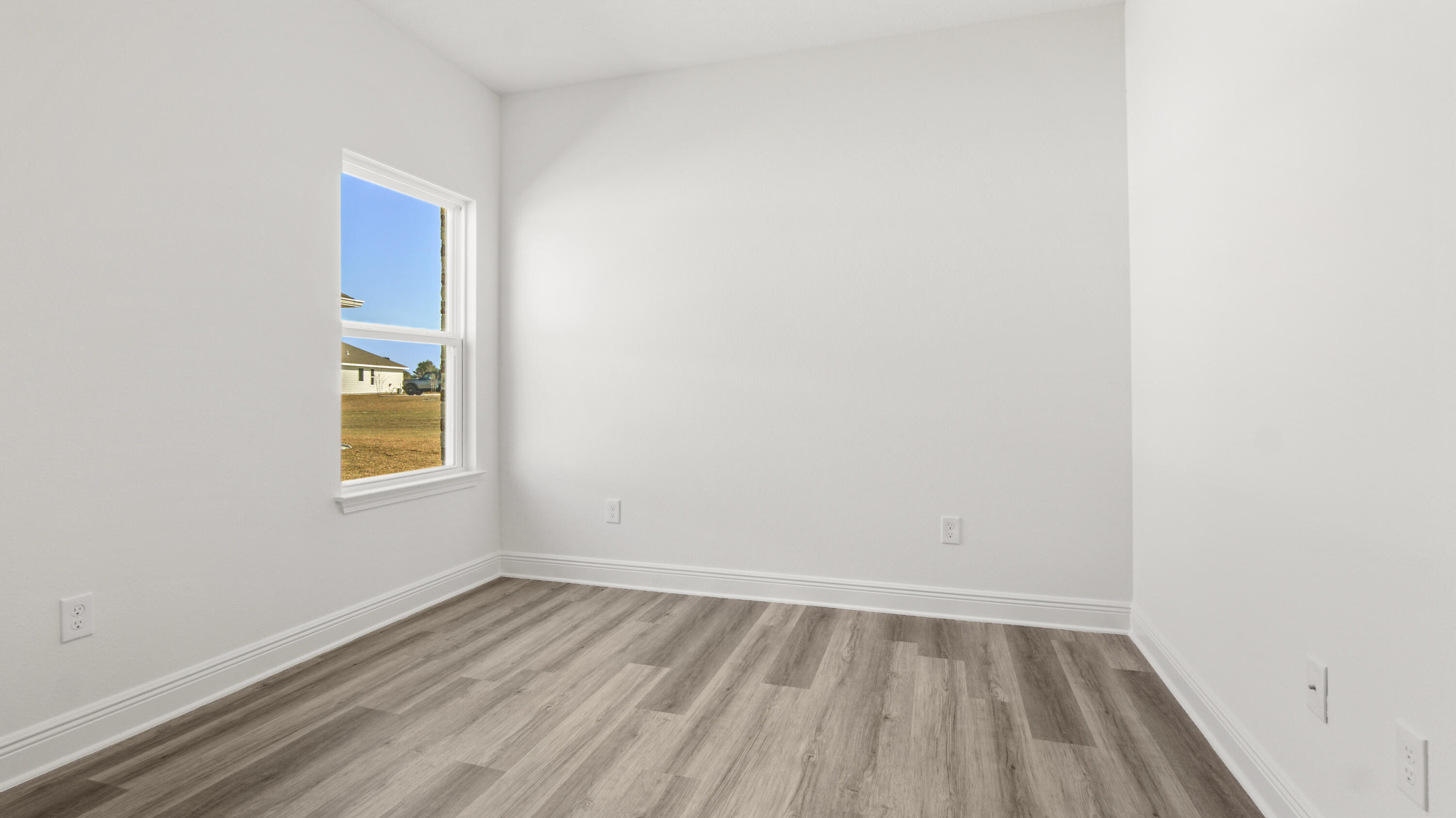 13 West W Farm Freeport, FL 32439 - Photo 9 of 38 a view of an empty room with wooden floor and a window
