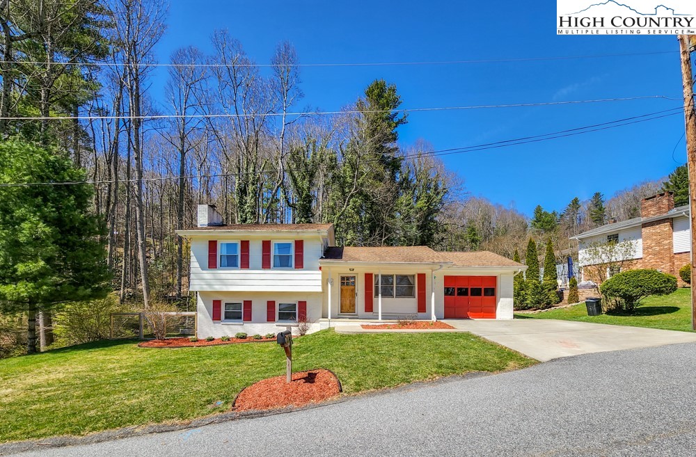 130 Chandy Street Boone, NC 28607 - Photo 2 of 21 a front view of a house with a garden and yard