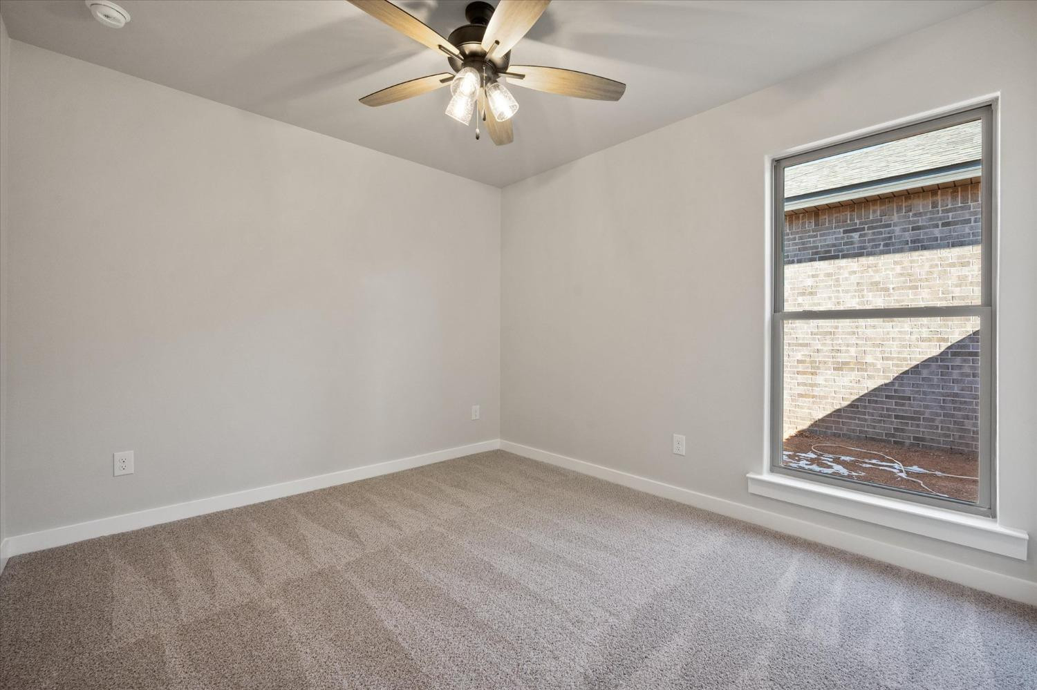 7429 30th Street Lubbock, TX 79407 - Photo 16 of 20 an empty room with a window and a fan