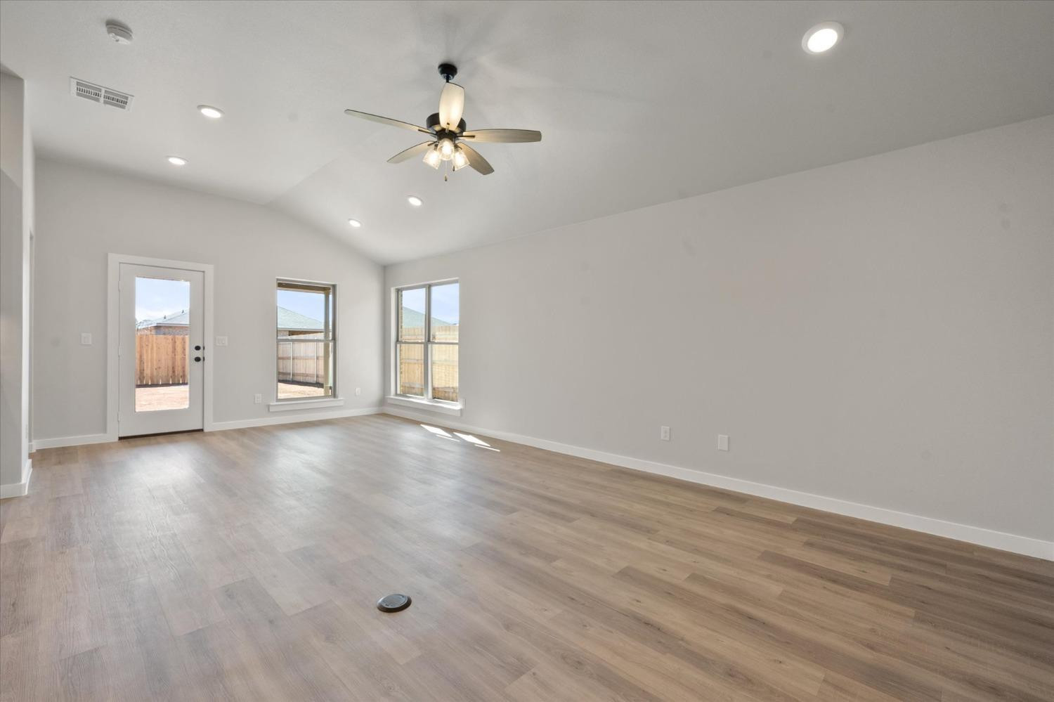 7429 30th Street Lubbock, TX 79407 - Photo 4 of 20 wooden floor in an empty room with a window