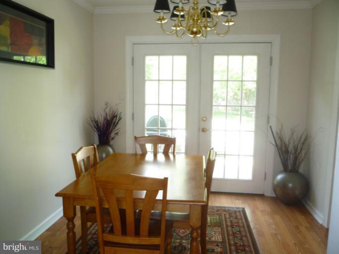 17221 Chiswell Road Poolesville, MD 20837 - Photo 1 of 23 a view of a dining room with furniture and chandelier
