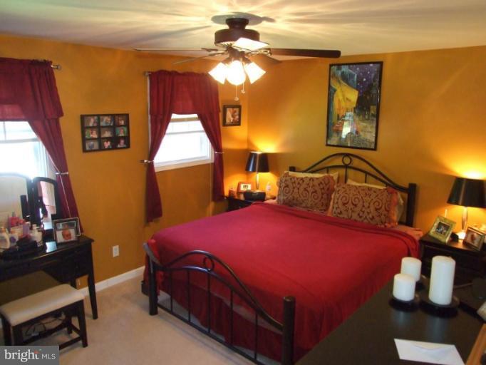 17221 Chiswell Road Poolesville, MD 20837 - Photo 15 of 23 a bedroom with a bed and wooden floor