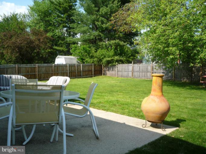17221 Chiswell Road Poolesville, MD 20837 - Photo 3 of 23 a backyard of a house with table and chairs