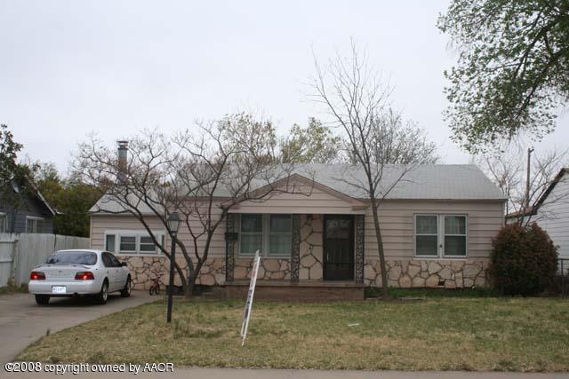 3625 South Travis Street Amarillo, TX 79110 - Photo 1 of 9 a front view of a house with a garden and plants