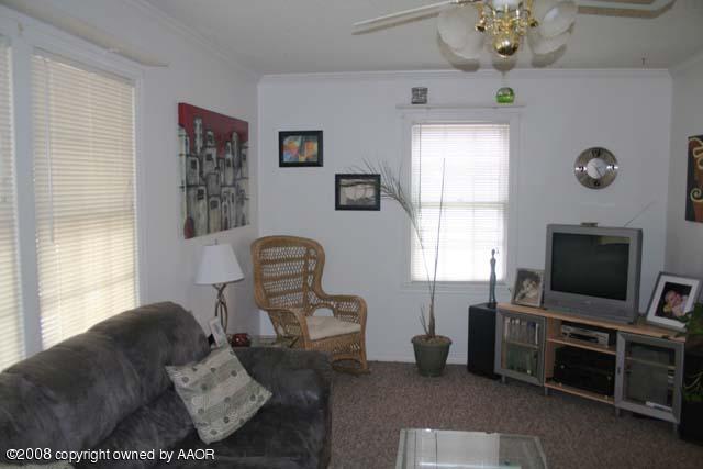 3625 South Travis Street Amarillo, TX 79110 - Photo 2 of 9 a living room with furniture and a flat screen tv