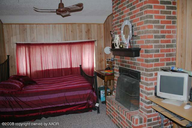 3625 South Travis Street Amarillo, TX 79110 - Photo 4 of 9 a room with furniture and a fireplace