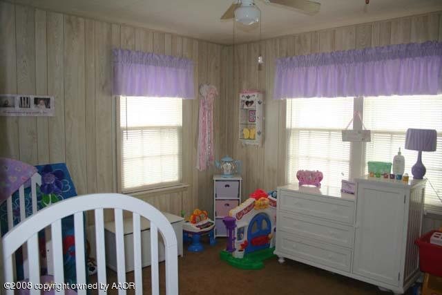 3625 South Travis Street Amarillo, TX 79110 - Photo 5 of 9 a bedroom with a bed and a window