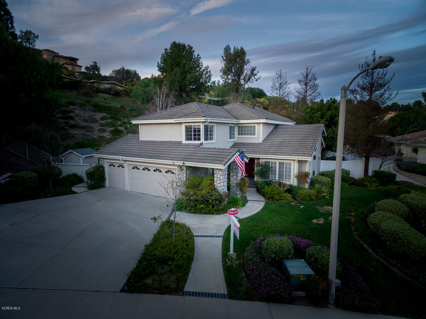 a front view of a house with a garden