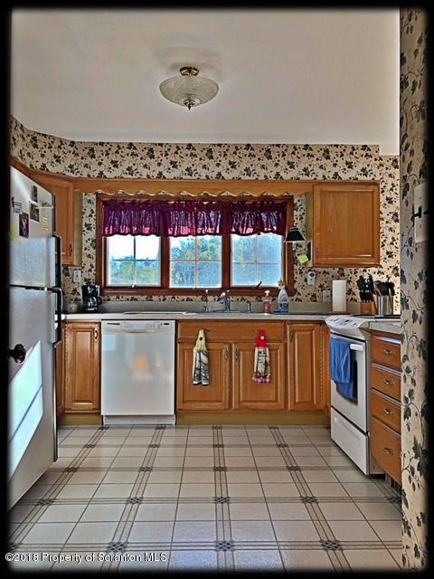 1345 Phillips Road Springville, PA 18844 - Photo 14 of 54 a kitchen with stainless steel appliances granite countertop a stove a sink and a microwave