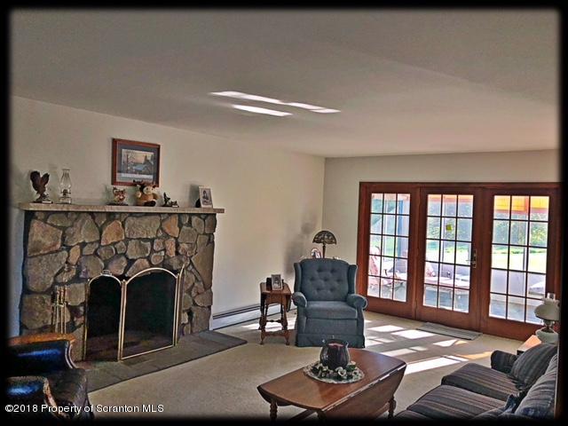 1345 Phillips Road Springville, PA 18844 - Photo 16 of 54 a living room with furniture a fireplace and a table