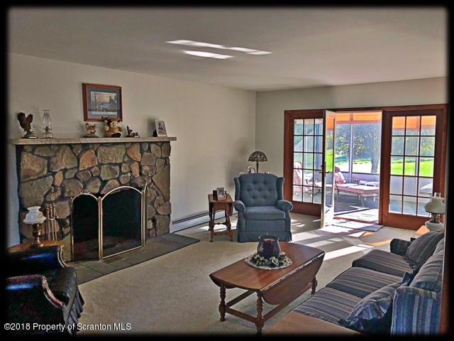 1345 Phillips Road Springville, PA 18844 - Photo 18 of 54 a living room with furniture and a fireplace