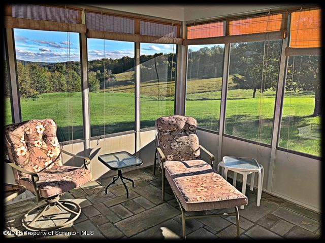 1345 Phillips Road Springville, PA 18844 - Photo 20 of 54 a living room with patio furniture and a floor to ceiling window