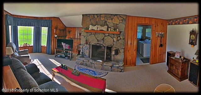 1345 Phillips Road Springville, PA 18844 - Photo 7 of 54 a living room with furniture a flat screen tv and a fireplace