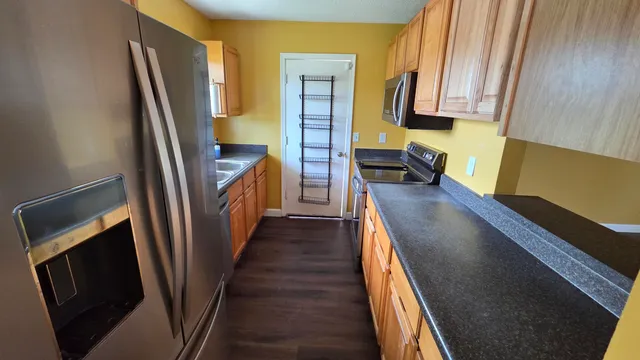 a kitchen with sink a refrigerator and cabinets
