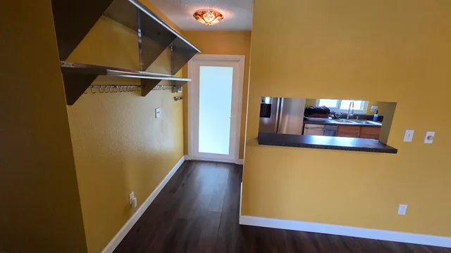 a view of a hallway with wooden floor