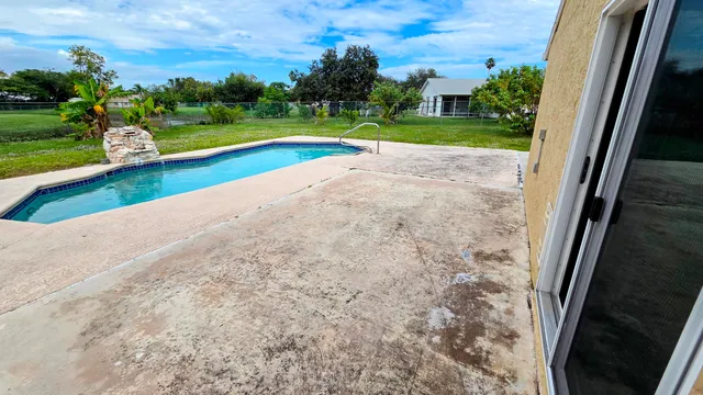 a view of swimming pool with a yard