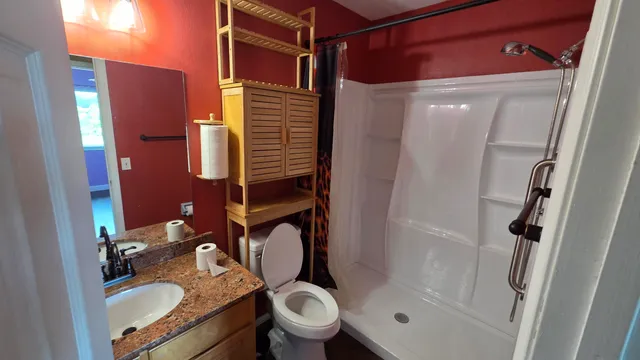 a bathroom with a sink toilet and shower