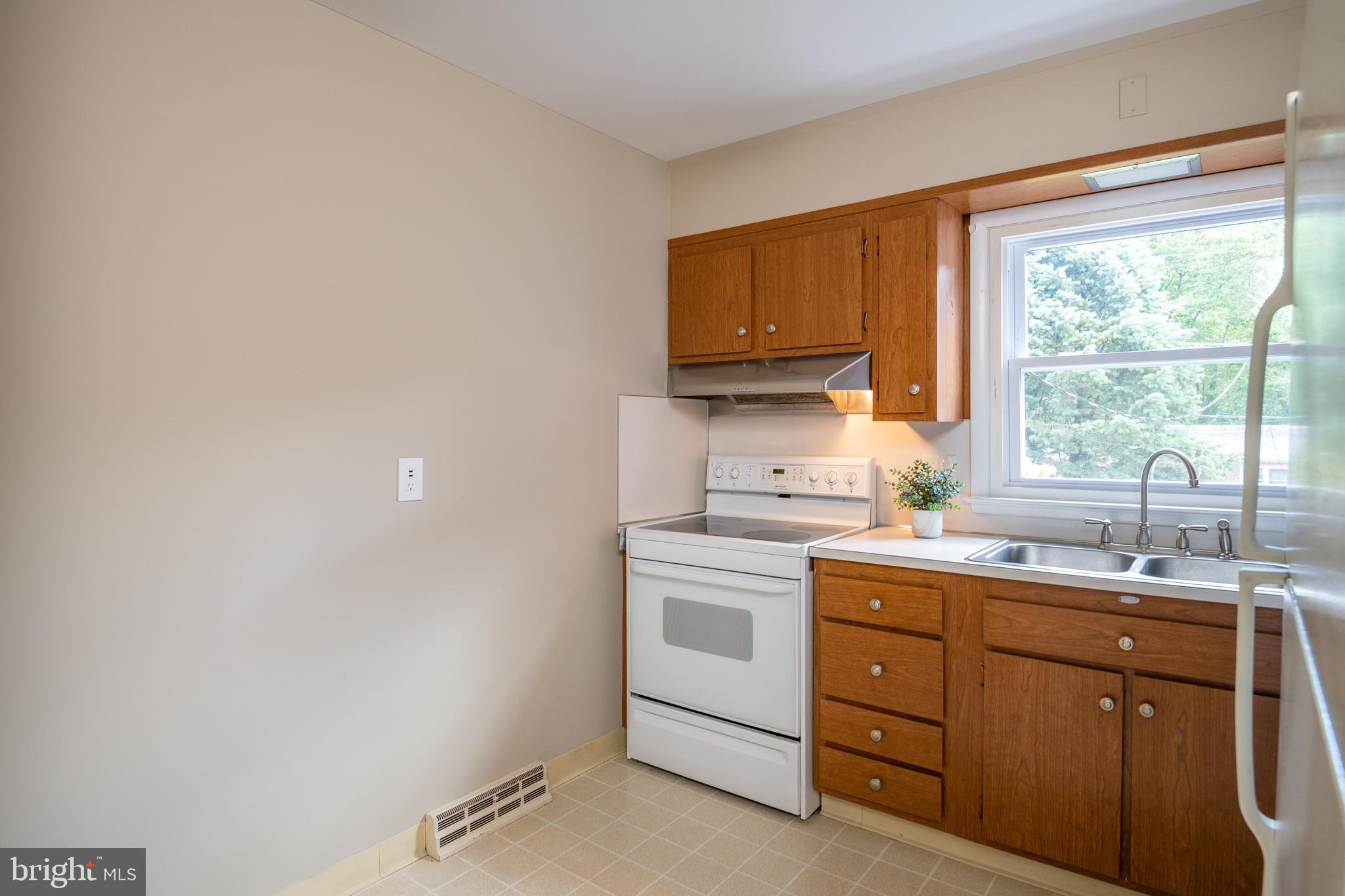 345 Sunset Road West Reading, PA 19611 - Photo 12 of 29 a kitchen with a sink stove and cabinets