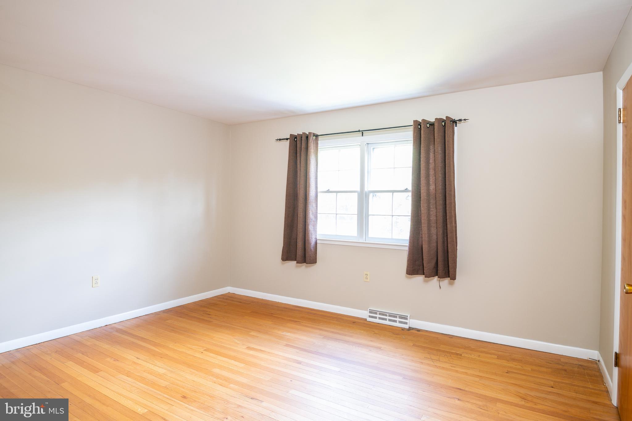 345 Sunset Road West Reading, PA 19611 - Photo 16 of 29 an empty room with wooden floor and windows