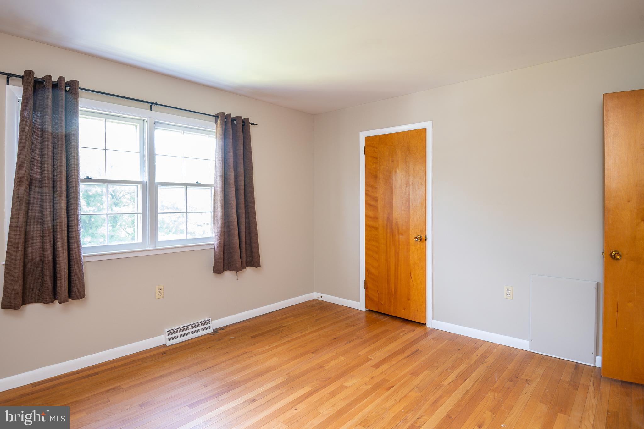 345 Sunset Road West Reading, PA 19611 - Photo 17 of 29 an empty room with wooden floor and windows
