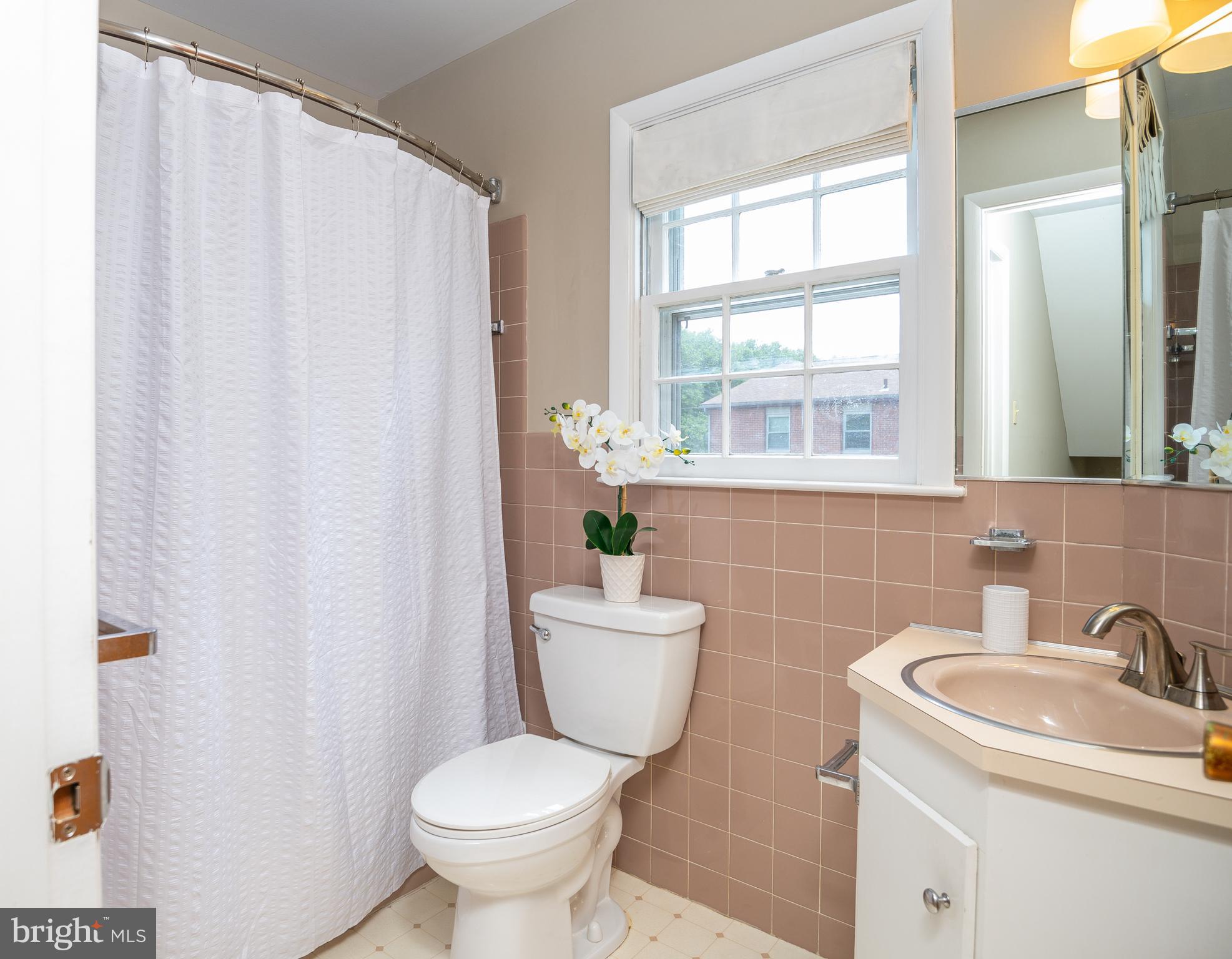 345 Sunset Road West Reading, PA 19611 - Photo 23 of 29 a bathroom with a sink mirror toilet and a window